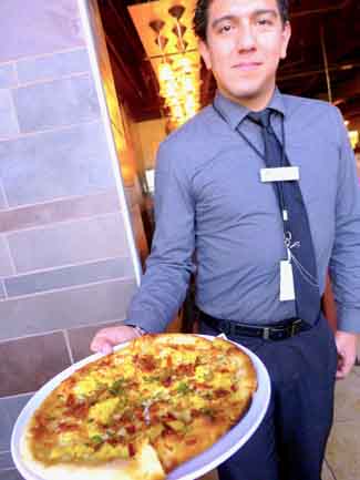 Luis delivers Puck breakfast pizza
