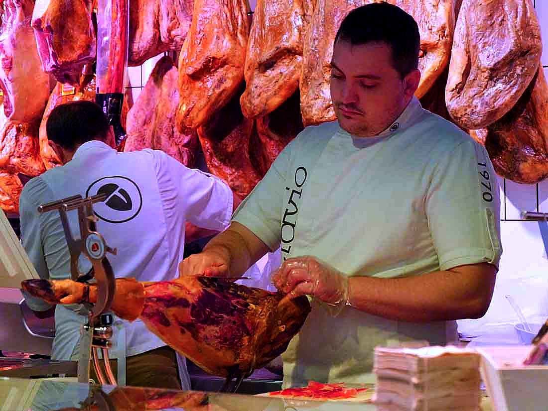 slicing ham at San Anton market in Madrid