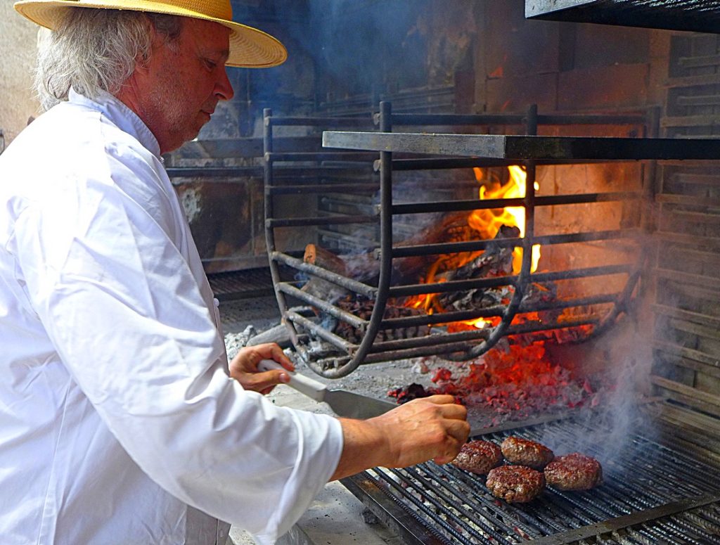 Francis Mallmann cooks hamburgers at Siete Fuegos