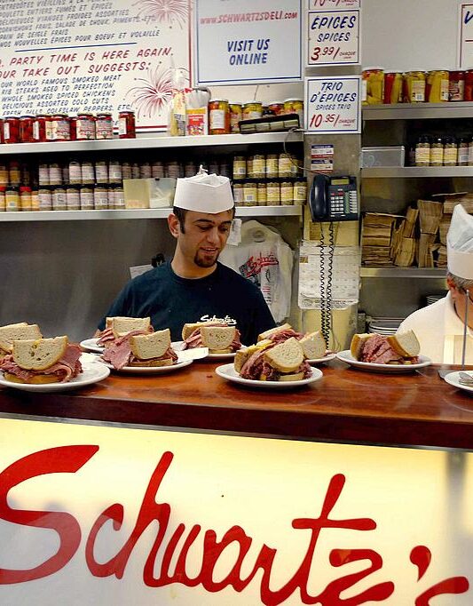 Cooks at Schwartz's turn out a steady stream of smoked meat sandwiches to meet what seems like an insatiable demand.